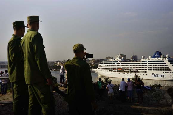 A soldiers takes pictures with his phones at the arrival of the Carnival Corp.'s Adonia to Havana from Miami in Havana, Cuba,Monday, May 2, 2016. AP Photo/Ramon Espinosa)