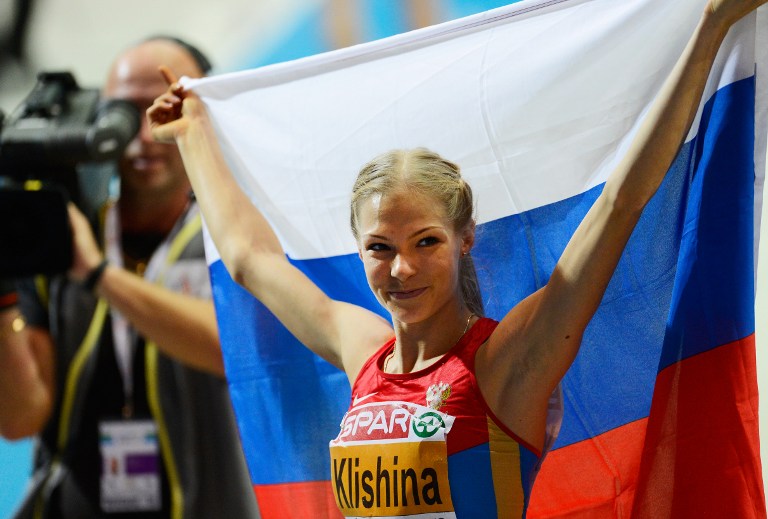 (FILES) This file photo taken on March 02, 2013 shows Russia's Darya Klishina celebrating after she won the women's Long Jump final at the European Indoor athletics Championships in Gothenburg, Sweden, on March 2, 2013. The International Olympic Committee on July 24, 2016, decided not hit Russia with a blanket for the Rio Games over state-run doping, but said each sports federation needed to establish an athlete's individual eligibility. The IAAF banned all of the Russian track and field team over allegations of state-sponsored doping but said athletes who prove they were not tainted by their country's corrupt system could be cleared. The IAAF has only permitted one Russian team member to compete in Rio as a neutral: US-based long jumper Darya Klishina. / AFP PHOTO / JONATHAN NACKSTRAND