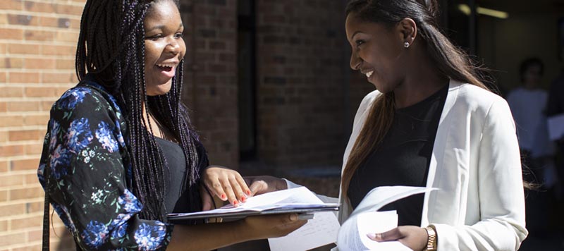 LONDON, ENGLAND - AUGUST 21: Girls react while opening their GCSE results at Stoke Newington school on August 21, 2014 in London, England. As hundreds of thousands of students opened their GCSE results today it has emerged that the proportion of GCSEs awarded A - C grade has risen to the highest in three years. (Photo by Dan Kitwood/Getty Images)