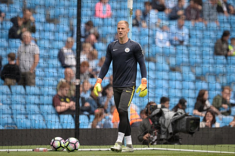 Manchester City's English goalkeeper Joe Hart warms up ahead of the English Premier League football match between Manchester City and Sunderland at the Etihad Stadium in Manchester, north west England, on August 13, 2016. Manchester City manager Pep Guardiola dropped goalkeeper Joe Hart in favour of Willy Caballero for his opening Premier League game against Sunderland on August 13. / AFP PHOTO / OLI SCARFF / RESTRICTED TO EDITORIAL USE. No use with unauthorized audio, video, data, fixture lists, club/league logos or 'live' services. Online in-match use limited to 75 images, no video emulation. No use in betting, games or single club/league/player publications.  /