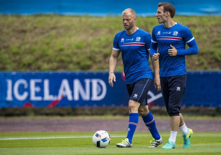 Iceland's forward Eidur Gudjohnsen (L) and Iceland's midfielder Theodor Bjarnason take part in a Euro 2016 training session at the d'Albigny sports center in Annecy le Vieux, south west France, on June 15, 2016.    / AFP PHOTO / ODD ANDERSEN