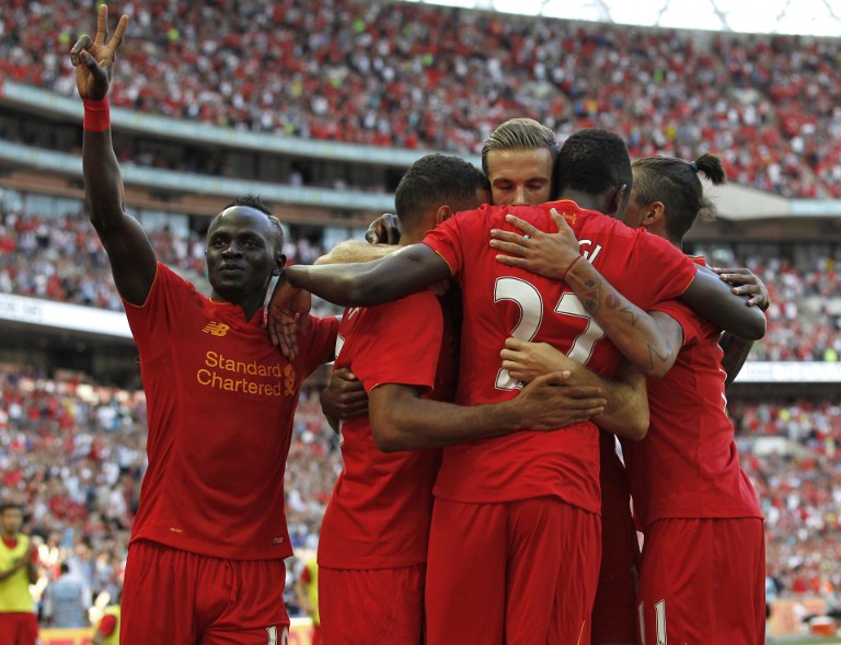 Liverpool's Belgian striker Divock Origi (2nd R) celebrates with teammates after scoring their third goal during the pre-season International Champions Cup football match between Spanish champions, Barcelona and Liverpool at Wembley stadium in London on August 6, 2016. / AFP PHOTO / Ian KINGTON