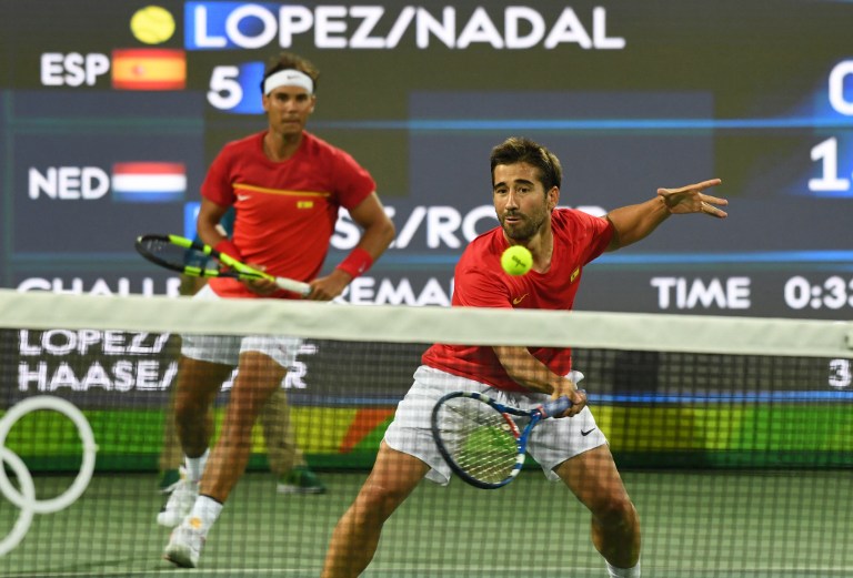 Spain's Rafael Nadal and Spain's Marc Lopez (R) return the ball to the Netherlands' Robin Haase and Jean-Julien Rojer during their men's first round doubles tennis match against at the Olympic Tennis Centre of the Rio 2016 Olympic Games in Rio de Janeiro on August 7, 2016. / AFP PHOTO / Luis Acosta