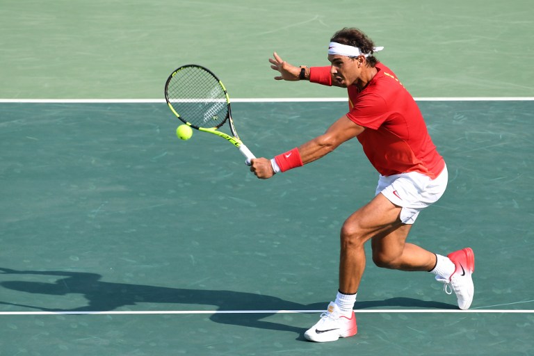 Spain's Rafael Nadal returns the ball to Italy's Andreas Seppi during their men's second round singles tennis match at the Olympic Tennis Centre of the Rio 2016 Olympic Games in Rio de Janeiro on August 9, 2016. / AFP PHOTO / Luis Acosta