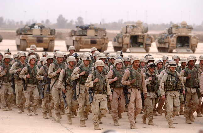 C2-7 Infantry soldiers march in formation to a memorial service for a fallen comrade Sunday, April 6, 2003 in front of the Task Force 3-69 operations center at Baghdad International Airport in Iraq. (AP Photo/San Antonio Express-News, Bahram Mark Sobhani)