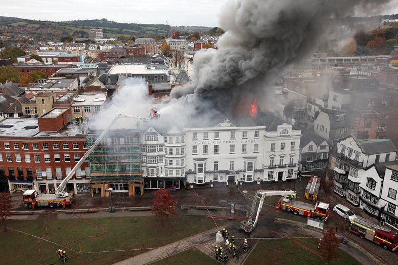 PIC: MARK PASSMORE/APEX 28/10/2016 Hundreds of firefighters are battling a blaze which has ripped through buildings in Exeter, including the "oldest hotel in England". The fire is believed to have started at an art gallery which faces Exeter Cathedral in Devon, but has now spread to the nearby Royal Clarence Hotel. Historian Dr Todd Gray said the buildings were "hugely significant". This picture shows plumes of smoke rising from the Royal Clarence Hotel. ** SEE STORY BY APEX NEWS - 01392 823144 ** ---------------------------------------------------- APEX NEWS AND PICTURES NEWS DESK: 01392 823144 PICTURE DESK: 01392 823145